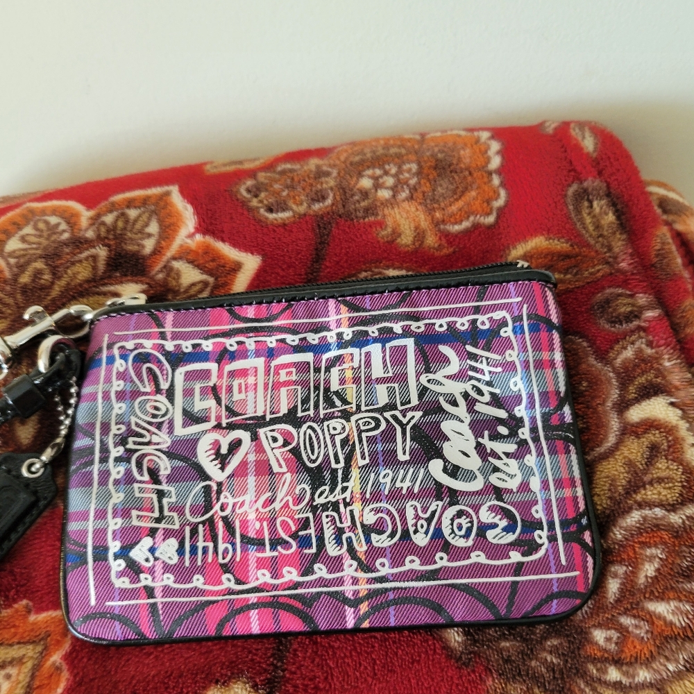 Coach Poppy tartan wristlet in pink and purple.